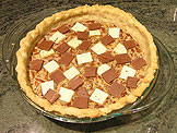  Placed each type of the chocolate pieces on top of the pie, one at a time to ensure they are evenly distributed